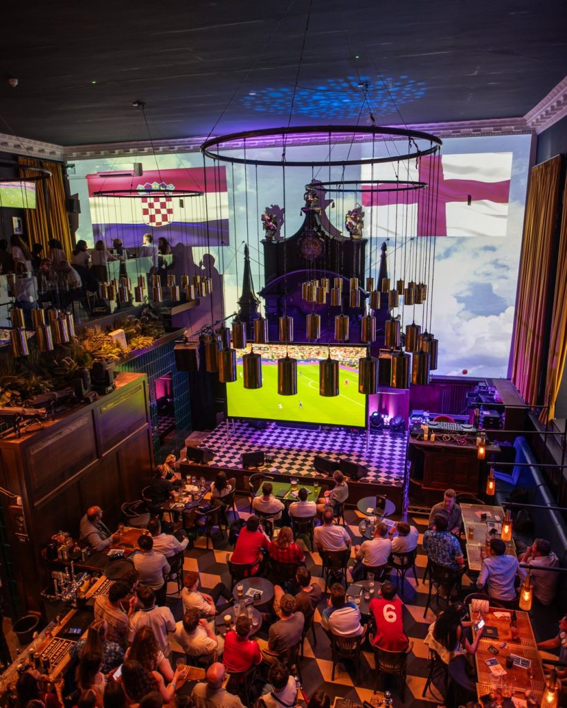 Excited football fans reacting to World Cup match at Amazing Grace London Bridge bar